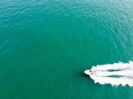 High Angle Footage and Aerial view of Ocean with High Speed Boats, People are having fun and enjoying hottest weather at Bournemouth Beach Sea Front of England UK. photo