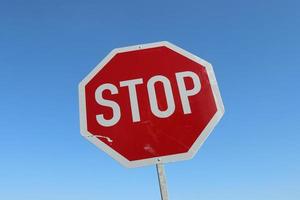 Stop sign against a clear blue sky. photo