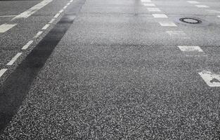 Different signs and marking painted on the ashpalt of streets and roads. photo