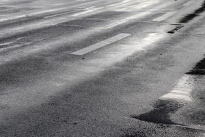 Different signs and marking painted on the ashpalt of streets and roads. photo