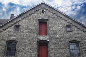 Old weathered and aged brick wall building. photo