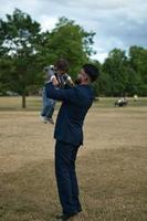 Asian Pakistani Father is holding his 11 Months Old Infant at Local Park photo