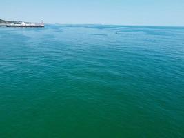 High Angle Footage and Aerial view of Ocean with High Speed Boats, People are having fun and enjoying hottest weather at Bournemouth Beach Sea Front of England UK. photo