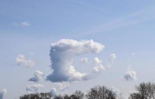 Beautiful fluffy white cloud formations in a deep blue summer sky photo