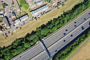 High Angle aerial view of British Roads and Traffic Passing through countryside of England UK photo