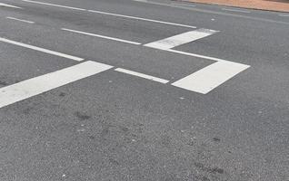 Different signs and marking painted on the ashpalt of streets and roads. photo