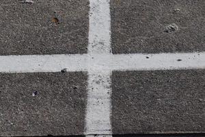 Different signs and marking painted on the ashpalt of streets and roads. photo