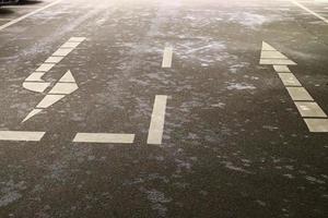 Different signs and marking painted on the ashpalt of streets and roads. photo