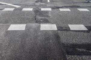 Different signs and marking painted on the ashpalt of streets and roads. photo