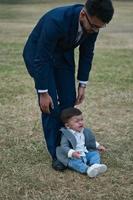 Asian Pakistani Father is holding his 11 Months Old Infant at Local Park photo