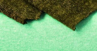 Detailed close up view on samples of cloth and fabrics in different colors found at a fabrics market photo
