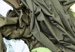 Detailed close up view on samples of cloth and fabrics in different colors found at a fabrics market photo