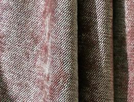 Detailed close up view on samples of cloth and fabrics in different colors found at a fabrics market photo