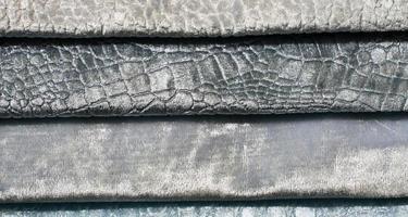 Detailed close up view on samples of cloth and fabrics in different colors found at a fabrics market photo