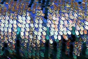 Detailed close up view on samples of cloth and fabrics in different colors found at a fabrics market photo