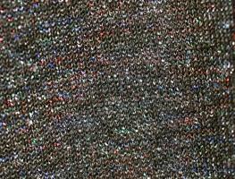 Detailed close up view on samples of cloth and fabrics in different colors found at a fabrics market photo