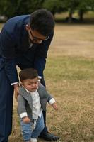 Asian Pakistani Father is holding his 11 Months Old Infant at Local Park photo