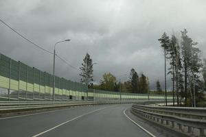 Turn on road. Fence on highway. Highway without cars. photo