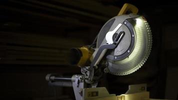 Milling saw for sawing boards. Disc tool in garage. Details of carpentry workshop. photo