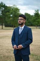 Young Businessman is posing at local park of Luton England UK photo