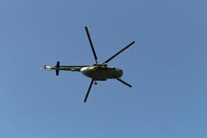 Helicopter in sky. Air transport flies across sky. Flight details. photo