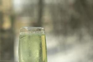 Shampoo in clear bottle. Glass detergent. Soapy substance. photo