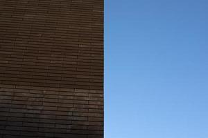 Wall of house is brown. Wall and sky. photo