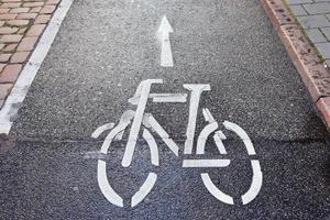 Painted bicycle signs on asphalt found in the city streets of Germany. photo