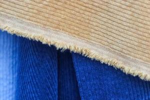 Detailed close up view on samples of cloth and fabrics in different colors found at a fabrics market photo