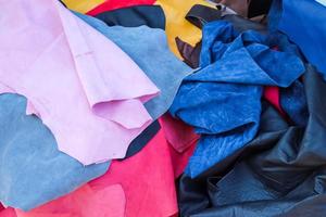 Detailed close up view on samples of cloth and fabrics in different colors found at a fabrics market photo
