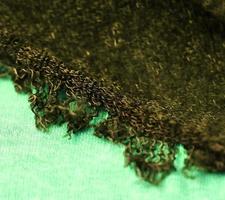 Detailed close up view on samples of cloth and fabrics in different colors found at a fabrics market photo