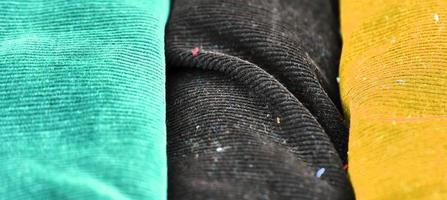 Detailed close up view on samples of cloth and fabrics in different colors found at a fabrics market photo