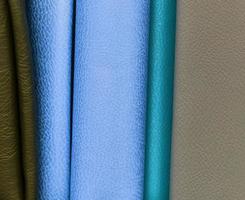 Detailed close up view on samples of cloth and fabrics in different colors found at a fabrics market photo