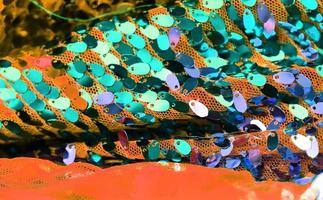Detailed close up view on samples of cloth and fabrics in different colors found at a fabrics market photo