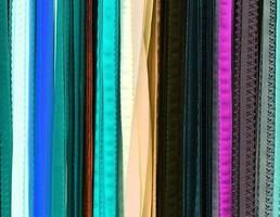 Detailed close up view on samples of cloth and fabrics in different colors found at a fabrics market photo