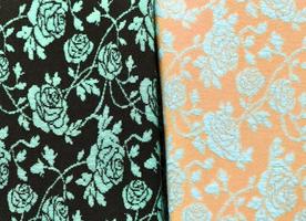 Detailed close up view on samples of cloth and fabrics in different colors found at a fabrics market photo