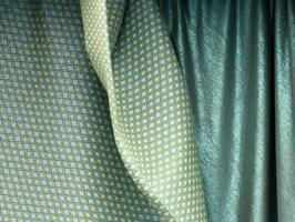 Detailed close up view on samples of cloth and fabrics in different colors found at a fabrics market photo