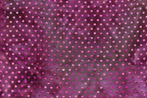 Detailed close up view on samples of cloth and fabrics in different colors found at a fabrics market photo
