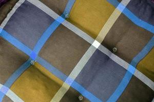Detailed close up view on samples of cloth and fabrics in different colors found at a fabrics market photo
