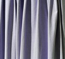 Detailed close up view on samples of cloth and fabrics in different colors found at a fabrics market photo