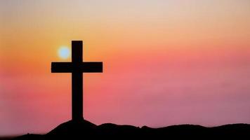 Silhouette Cross on the mountains photo