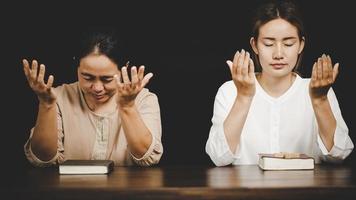 Two women praying worship believe photo