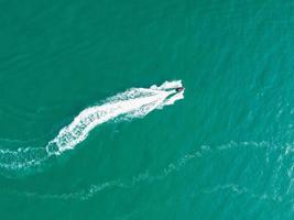 High Angle Footage and Aerial view of Ocean with High Speed Boats, People are having fun and enjoying hottest weather at Bournemouth Beach Sea Front of England UK. photo