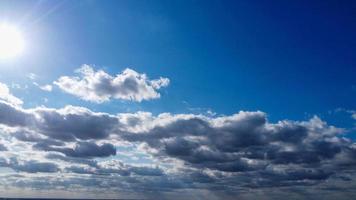 Blue Clear Sky and Few Clouds over England on Hot Summer Day photo