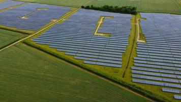 Aerial footage High Angle view of Green Energy natural Generators Sources of Wind turbines and solar panels Farms at England UK photo