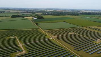 Aerial footage High Angle view of Green Energy natural Generators Sources of Wind turbines and solar panels Farms at England UK photo