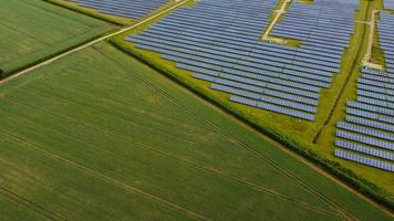 Aerial footage High Angle view of Green Energy natural Generators Sources of Wind turbines and solar panels Farms at England UK photo