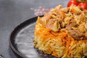 Pilaf or pilau with chicken, traditional uzbek hot dish of boiled rice and chicken meat photo