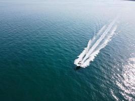 High Angle Footage and Aerial view of Ocean with High Speed Boats, People are having fun and enjoying hottest weather at Bournemouth Beach Sea Front of England UK. photo