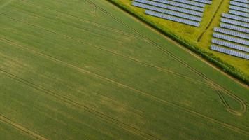 Aerial footage High Angle view of Green Energy natural Generators Sources of Wind turbines and solar panels Farms at England UK photo